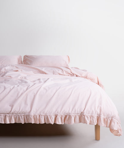 Pristine stonewashed cotton pillowcase styled on modern bed with neutral bedding – soft eco-friendly fabric by Limasso London