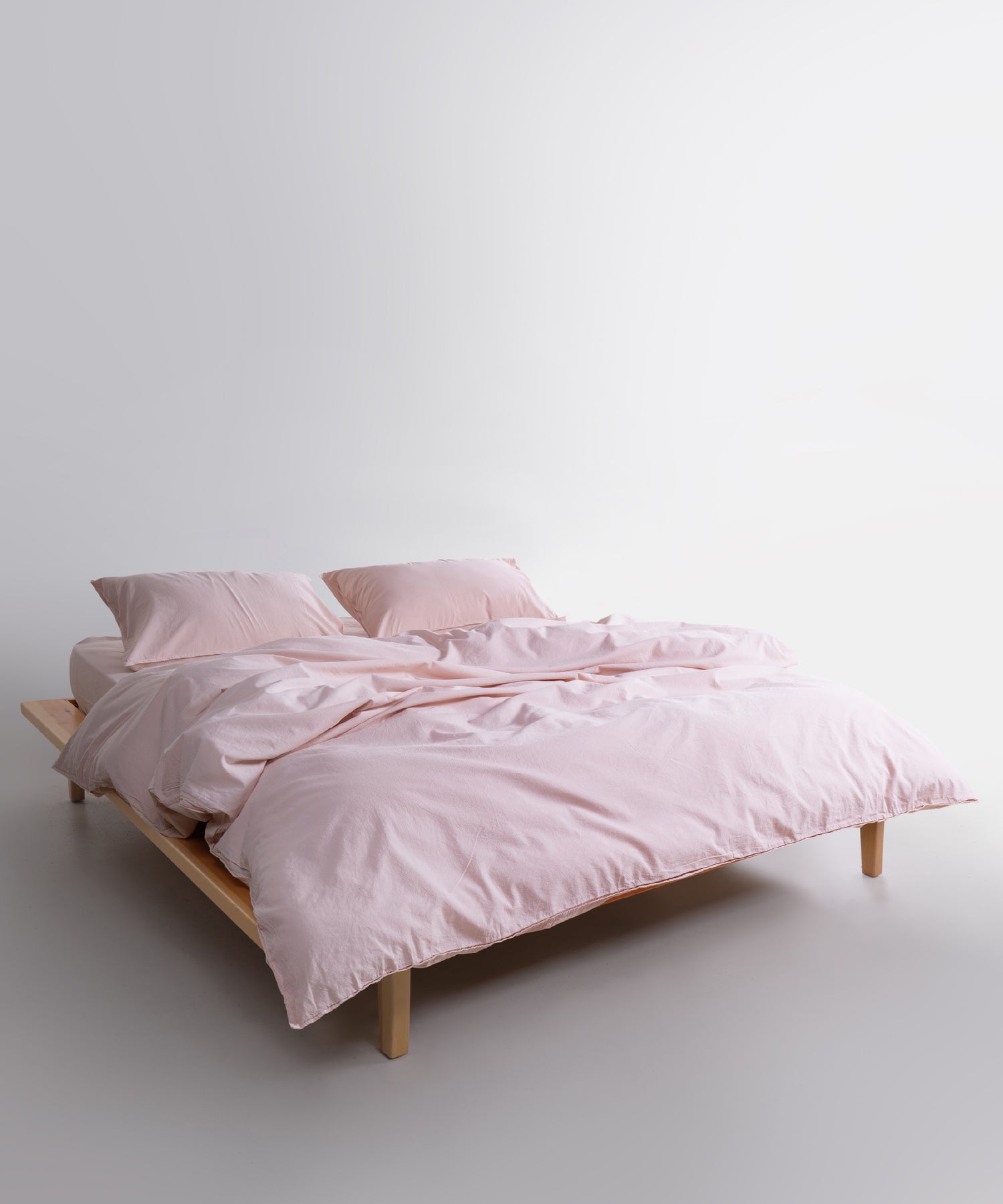 Pristine stonewashed cotton duvet cover set styled in modern bedroom with soft white pillowcases