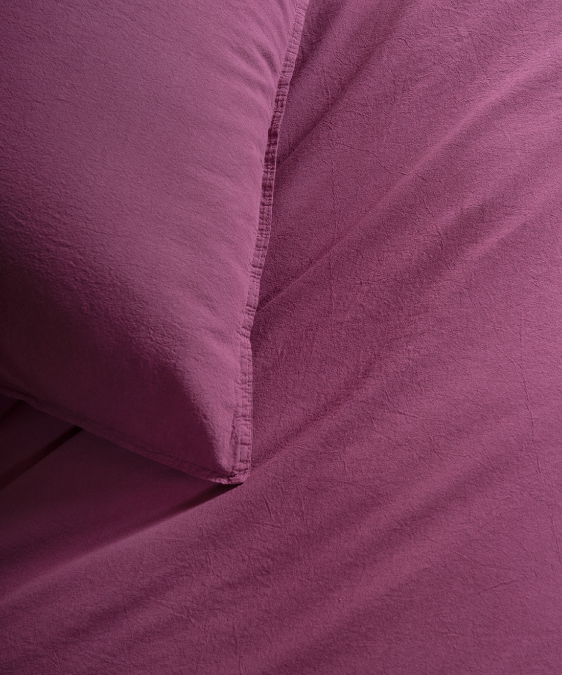 Complete Raspberry stonewashed cotton duvet cover and pillowcase set, soft breathable bedding available in UK and US sizes.