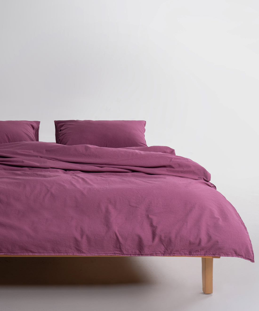 Stonewash 100% soft cotton duvet cover set in Raspberry colour, breathable luxury bedding available in UK and US sizes.