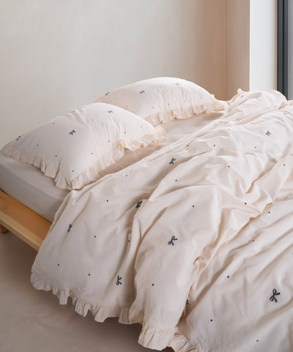 Garment washed cream cotton duvet cover set with jacquard ribbon and ruffled edge detail – Limasso London