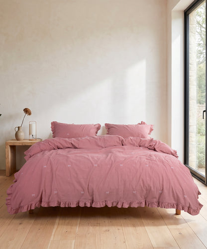 Old rose 100% cotton duvet cover set with ribbon pattern styled on a bed – Limasso London