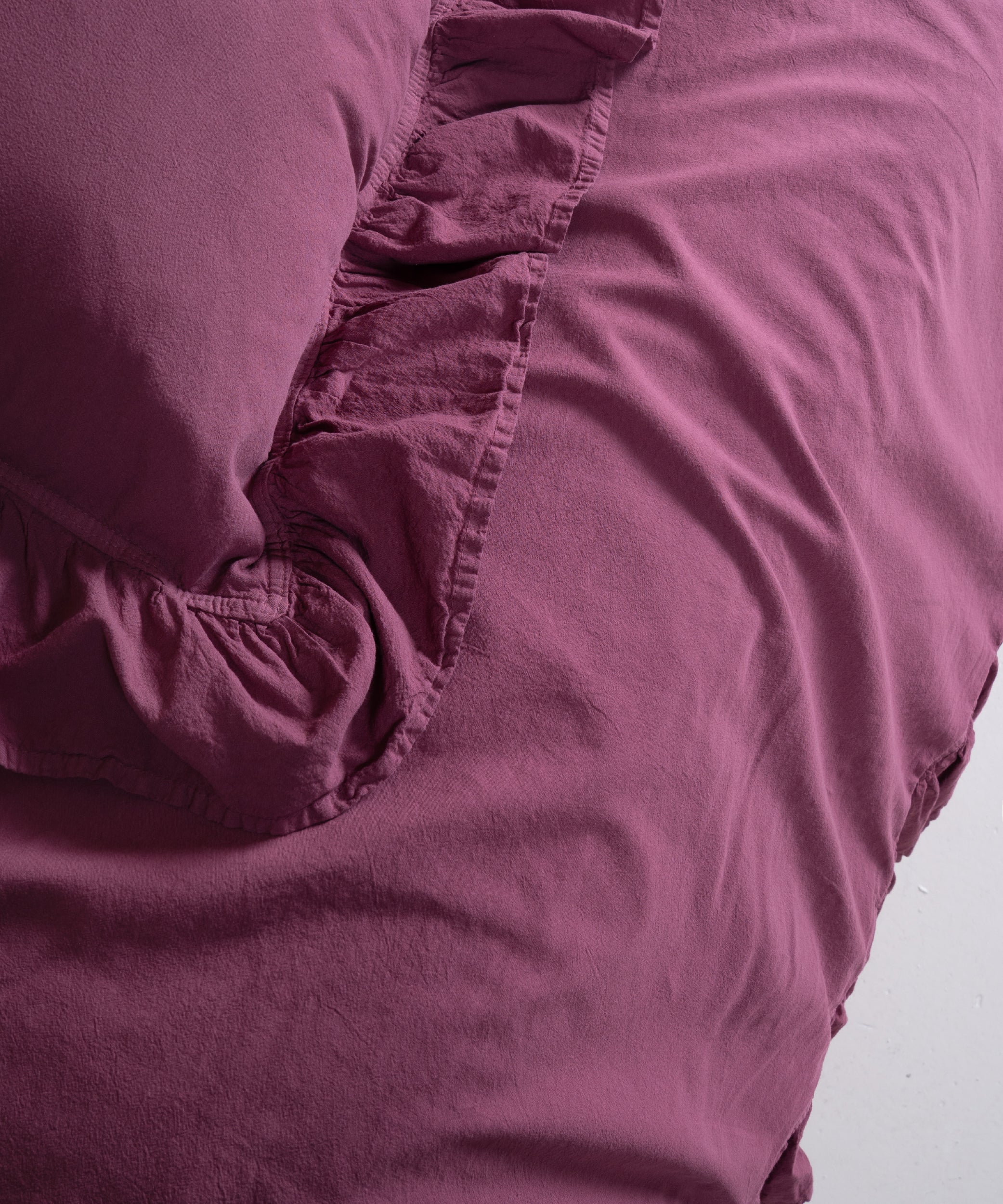 Elegant ruffle trim detail on Raspberry stonewashed cotton duvet cover set with double-stitched edges and premium finishing.