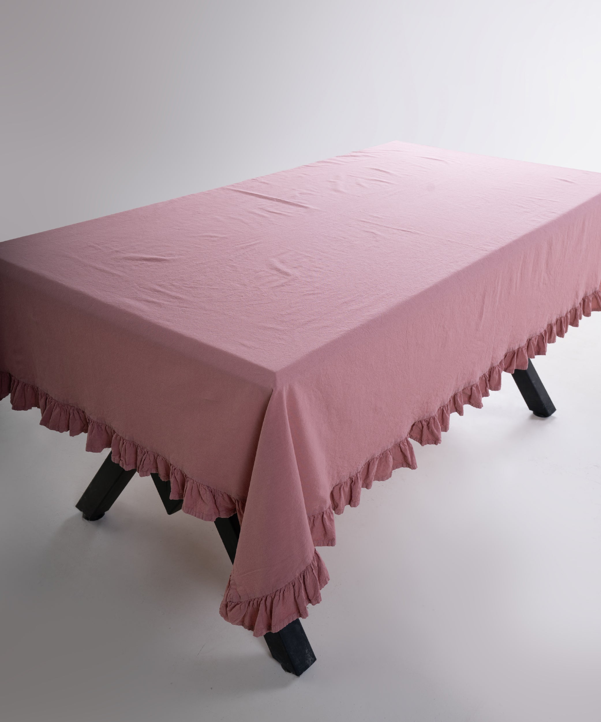 Detailed view of ruffled edge on Old Rose 100% cotton stonewashed tablecloth, elegant pink dining table linen UK