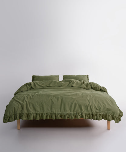 Close up of Sicilia Capulet Olive stonewashed cotton duvet cover with elegant ruffle lace trim detail