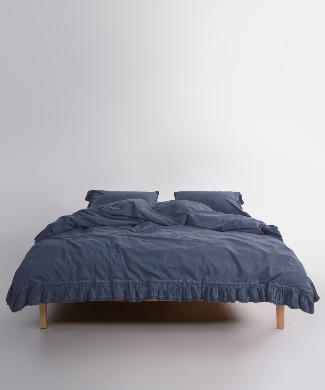 Close up of Sicilia Castle Rock stonewashed cotton duvet cover with elegant ruffle lace trim detail
