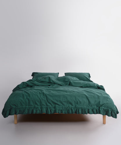 Close up of Sicilia Dark Green stonewashed cotton duvet cover with elegant ruffle lace trim detail