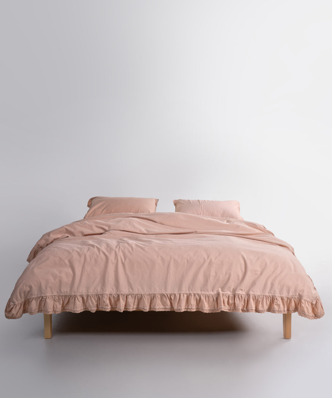Close up of Sicilia Mediterranean Beige stonewashed cotton duvet cover with elegant ruffle lace trim detail