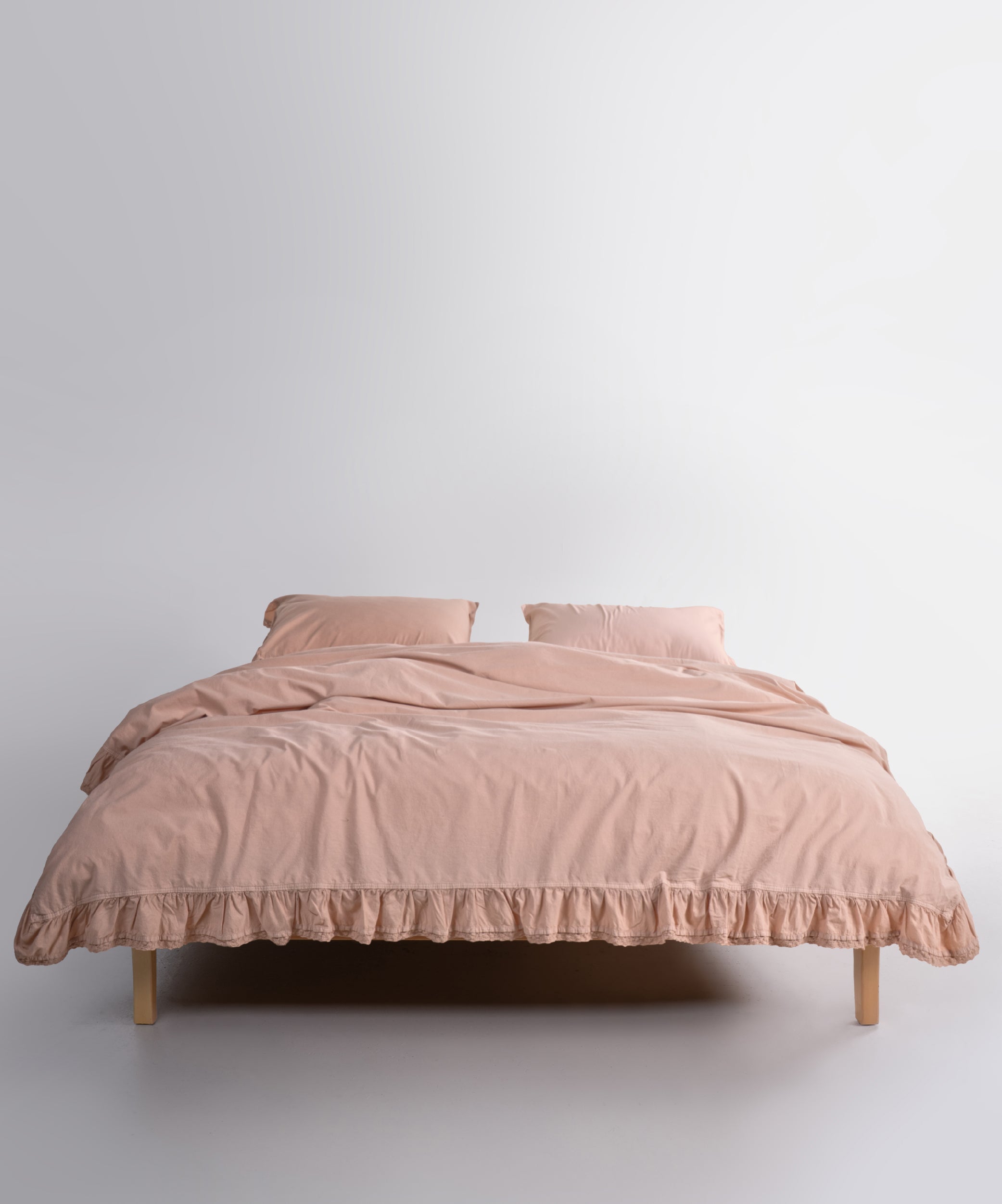Close up of Sicilia Mediterranean Beige stonewashed cotton duvet cover with elegant ruffle lace trim detail