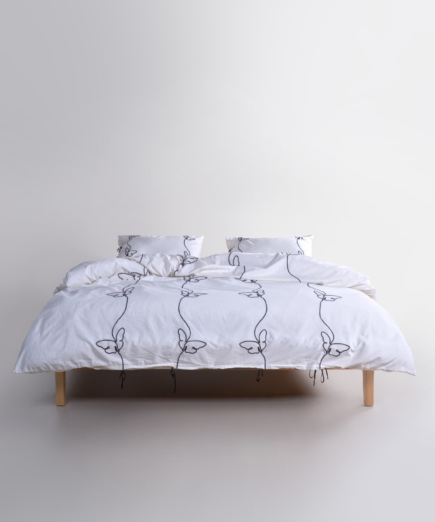 Styled full bed image featuring the Snow White butterfly embroidered duvet cover set for a bright, calm and elegant bedroom look.