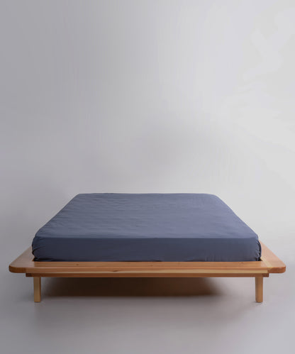 Stonewashed 100% cotton fitted sheet in natural grey with elasticated corners for a secure and comfortable fit