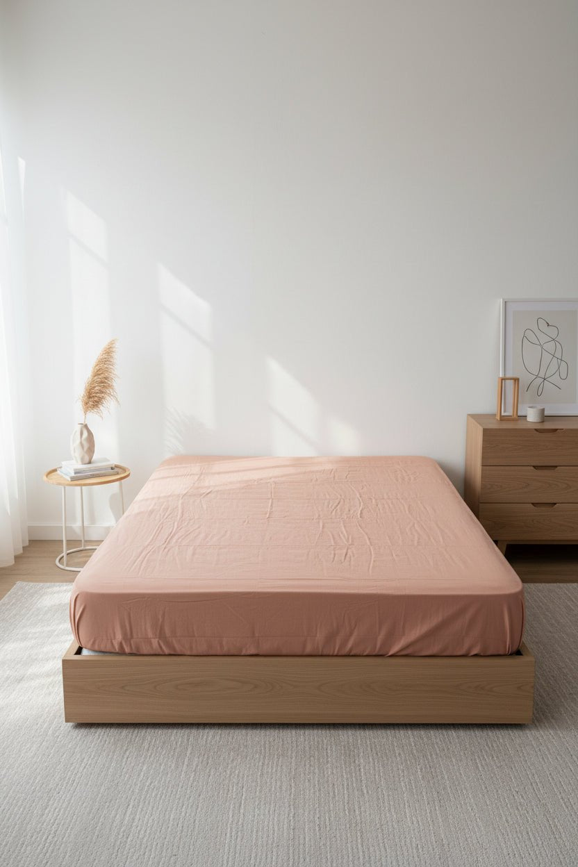 Stonewashed 100% cotton fitted sheet in Commercer colour by Limasso London, featuring a soft neutral beige-brown tone, breathable fabric and a smooth, modern bedroom setting.