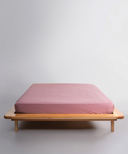 Old Rose stonewashed 100% cotton fitted sheet with soft natural texture and breathable finish, designed for UK mattresses.