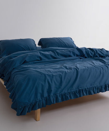 Close-up of stonewashed 100% cotton fabric in dress blue showing soft texture, breathable weave and natural finish