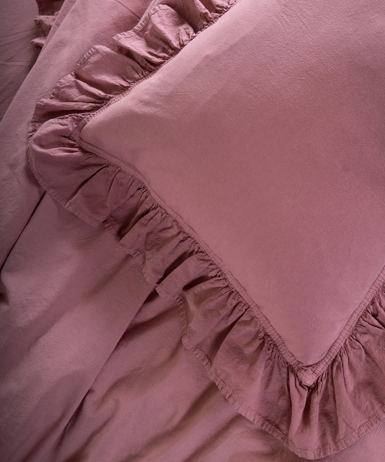 Old Rose stonewashed 100% cotton pillowcase with soft ruffle edge and breathable natural fabric, designed for elegant UK bedrooms.