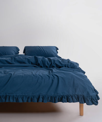 Stonewash exclusive 100% soft cotton duvet cover set in dress blue, styled on a bed in an elegant UK bedroom interior