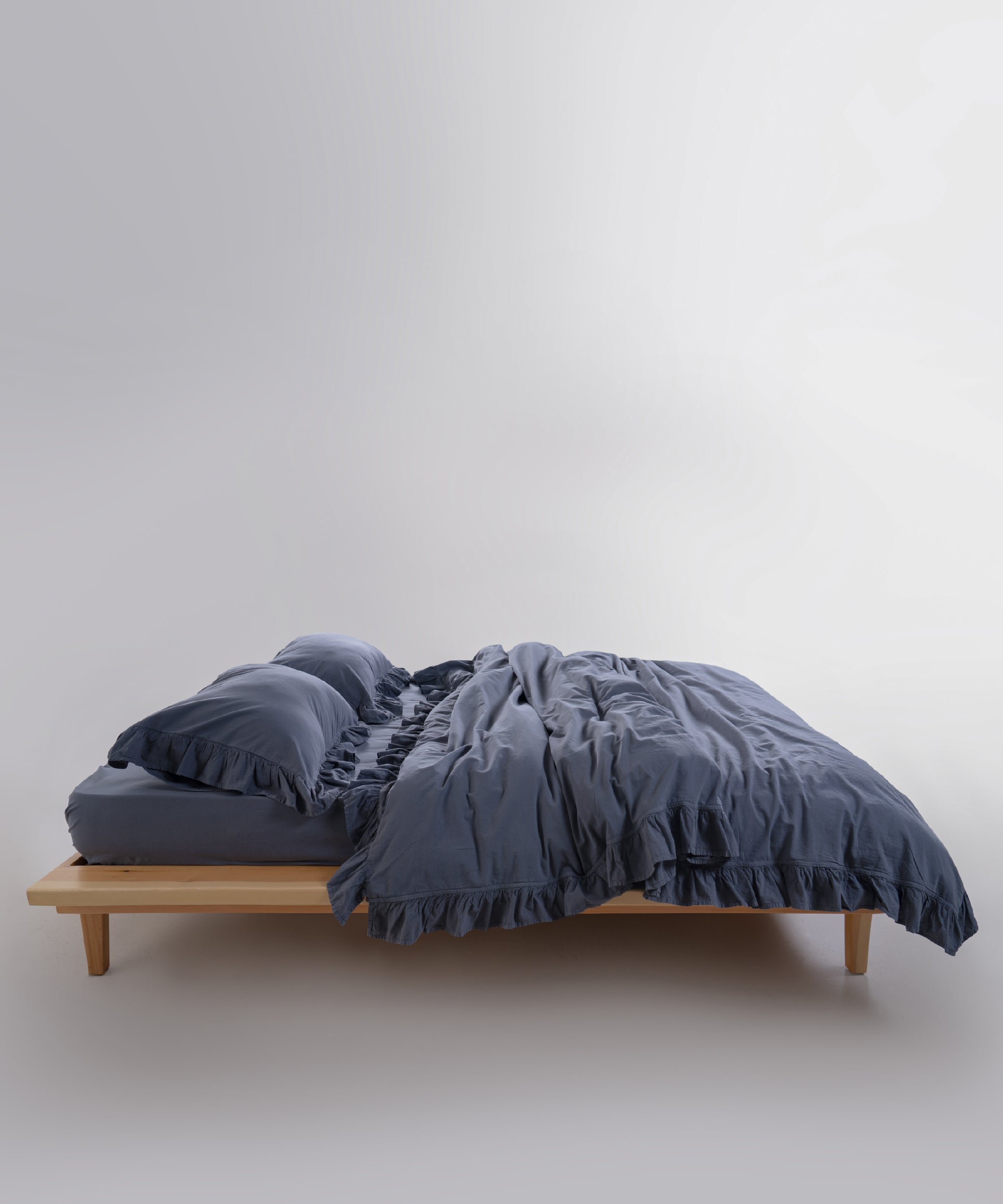 Stonewashed cotton duvet cover set in natural grey featuring elegant ruffle detailing and premium stitching