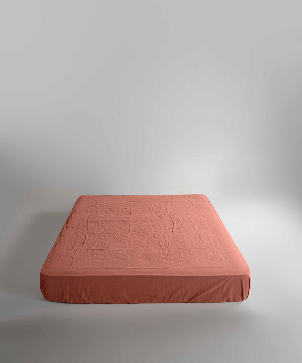 Limasso stonewashed 100% cotton fitted sheet in Mecca Orange, soft breathable orange bed sheet with elasticated corners, suitable for UK mattresses.