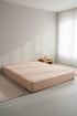 Stonewashed 100% cotton fitted sheet in med beige, styled on a modern bed. Soft, breathable natural cotton with a relaxed stonewashed finish, designed to fit UK mattresses securely.