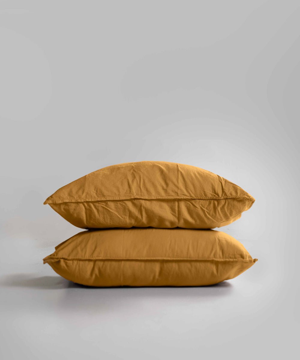Two-piece stonewashed 100% cotton pillowcase set in Mustard colour (50x75cm). Soft, breathable and durable with double-needle stitching and envelope flap closure – perfect for everyday comfort and a warm, stylish bedroom look.