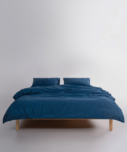 Close-up of stonewashed 100% cotton fabric in dress blue showing soft texture and breathable weave