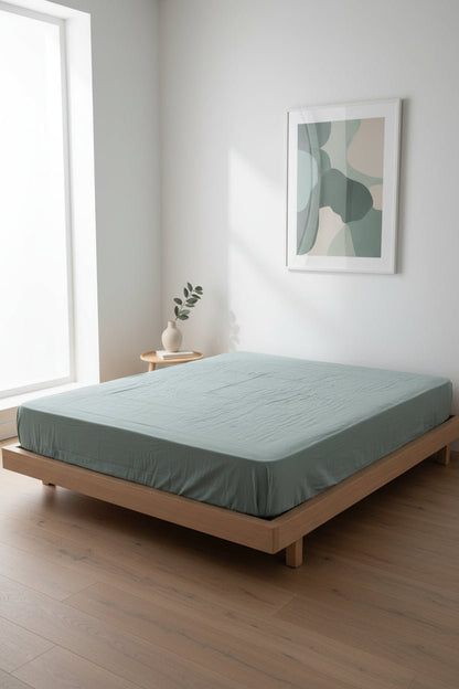 Stonewashed 100% cotton fitted sheet in Natural Green. Soft, breathable and naturally textured, designed for UK mattresses with deep fit options up to 40 cm.