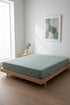 Stonewashed 100% cotton fitted sheet in Natural Green. Soft, breathable and naturally textured, designed for UK mattresses with deep fit options up to 40 cm.