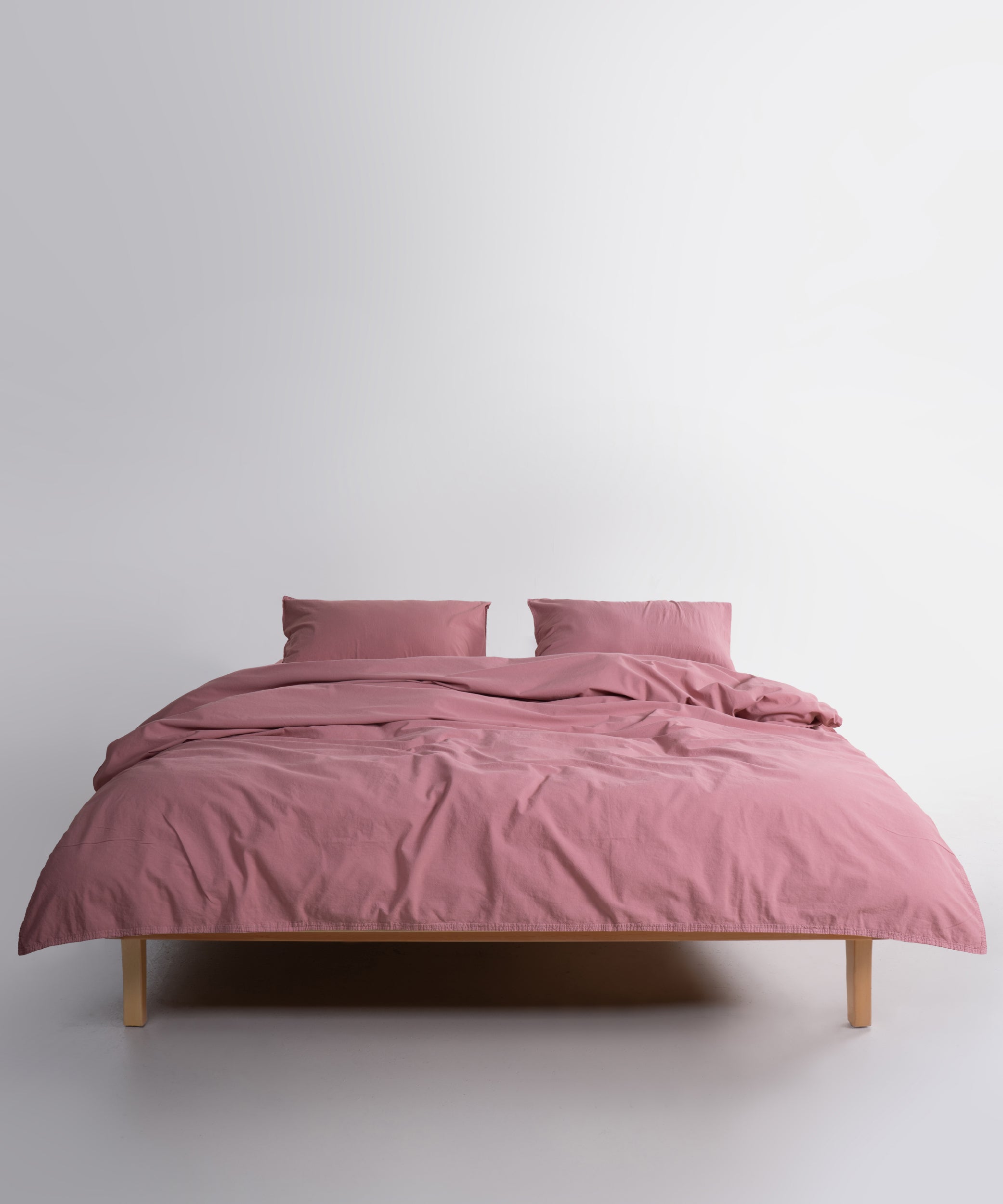 Close-up of stonewashed 100% cotton fabric in Old Rose showing soft texture and breathable weave