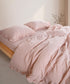 Pristine stonewashed 100% cotton duvet cover set with ruffled edges styled on modern UK bed