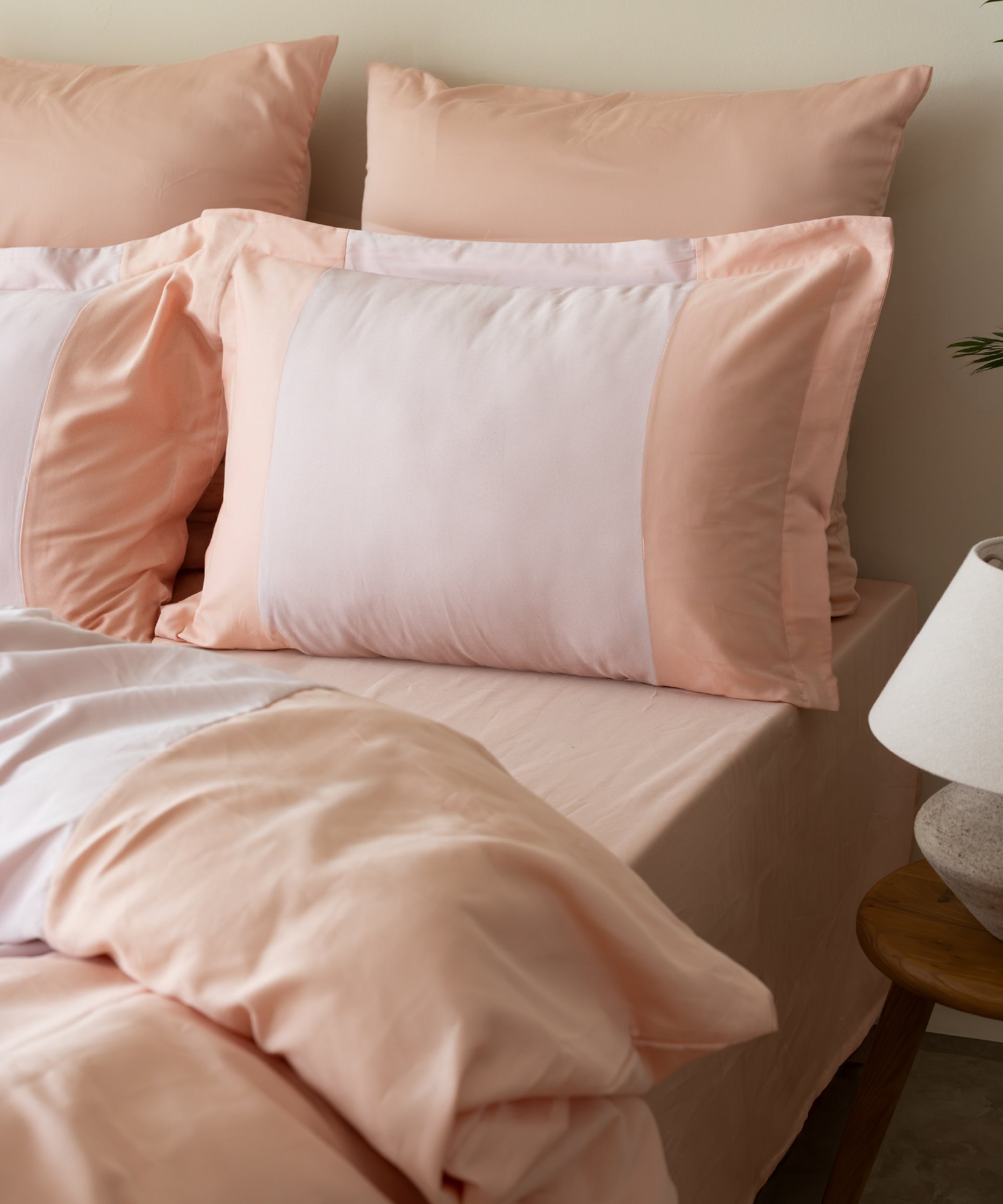 210 Thread Count Sateen Duvet Cover Set Toast and Pristine angled view showing reversible two-tone design – Limasso London