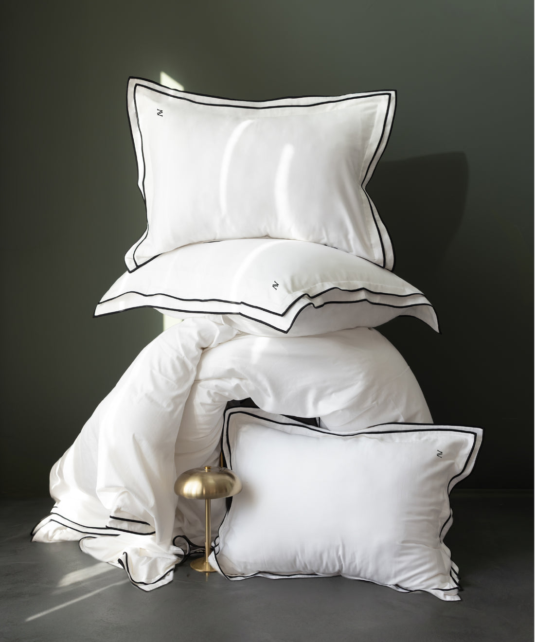 Close-up of white cotton sateen fabric showing smooth silky texture and subtle sheen luxury bedding