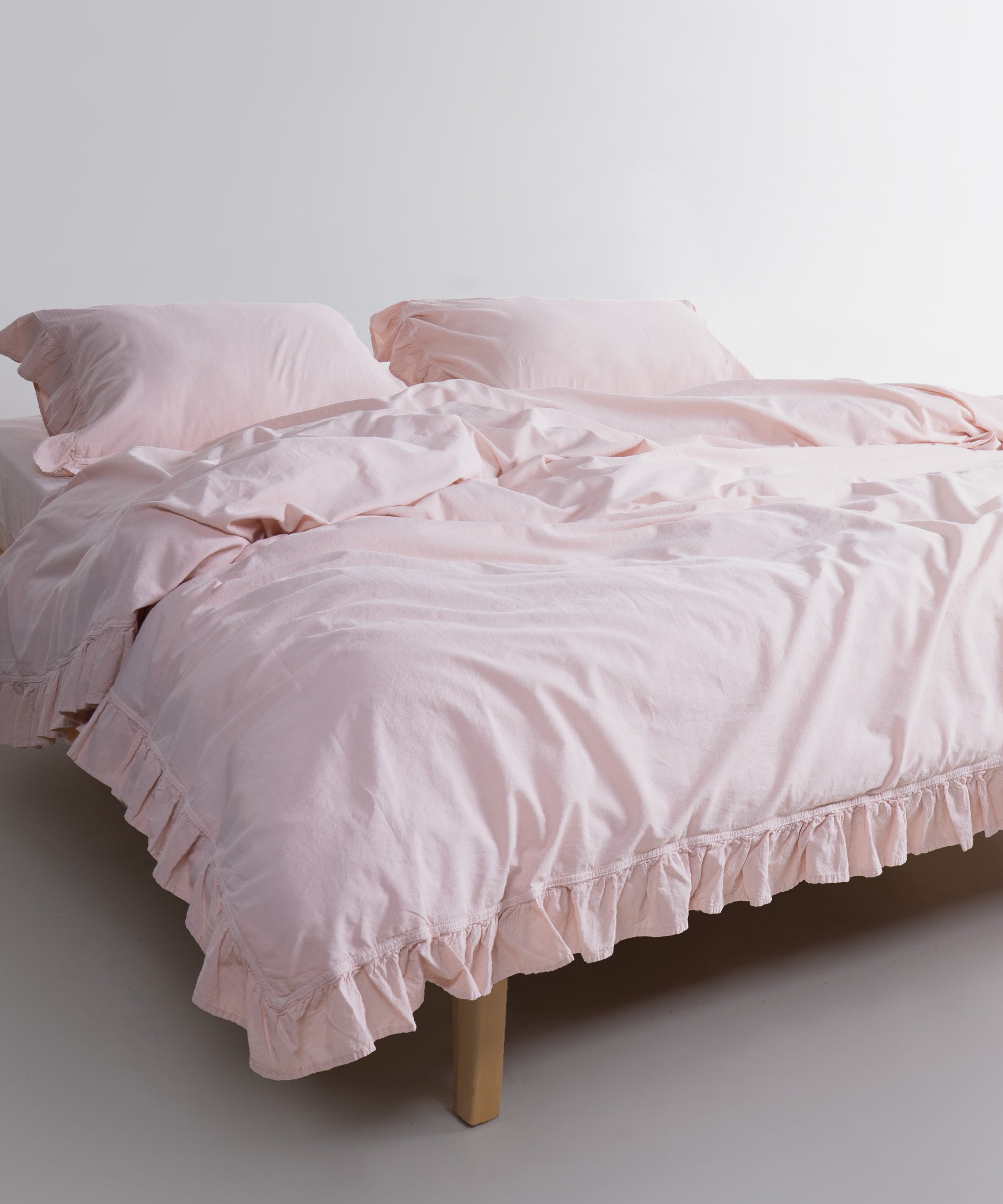 Pristine white stonewashed cotton duvet cover set styled in modern bedroom with matching pillowcases