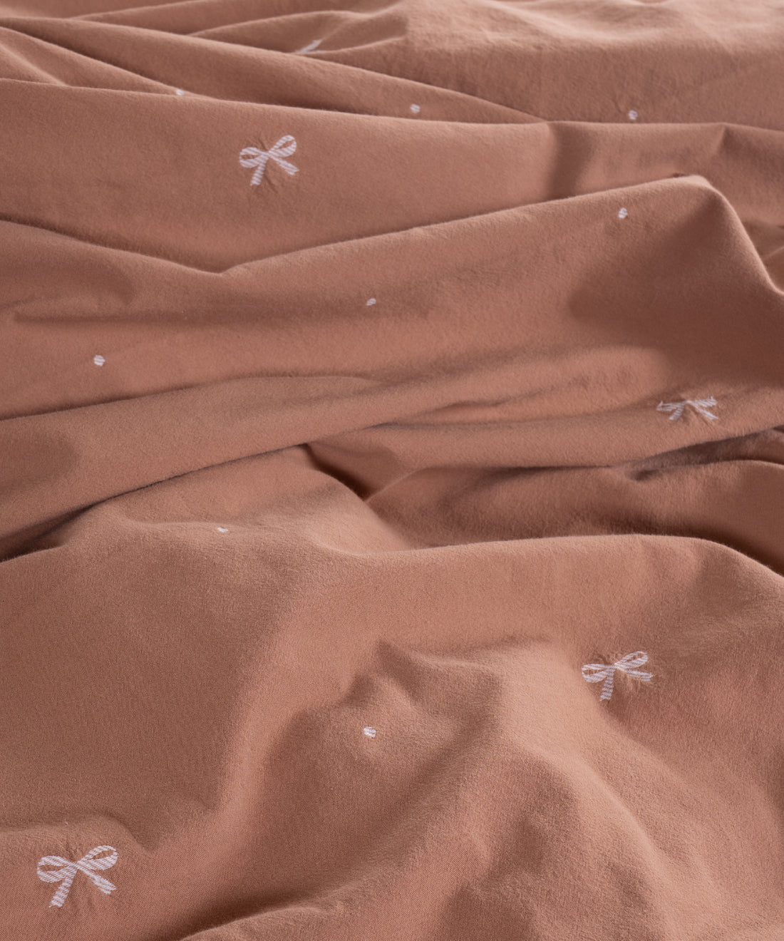Close-up of stonewashed 100% cotton fabric in Wood Smoke showing soft breathable texture