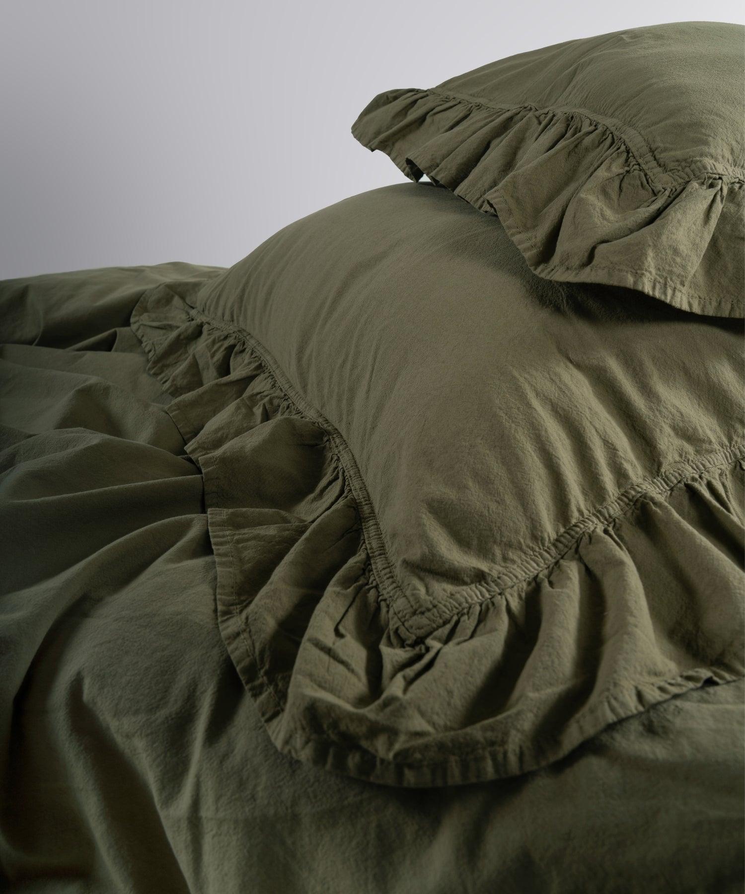 Button closure detail on stonewashed cotton duvet cover set by Limasso London
