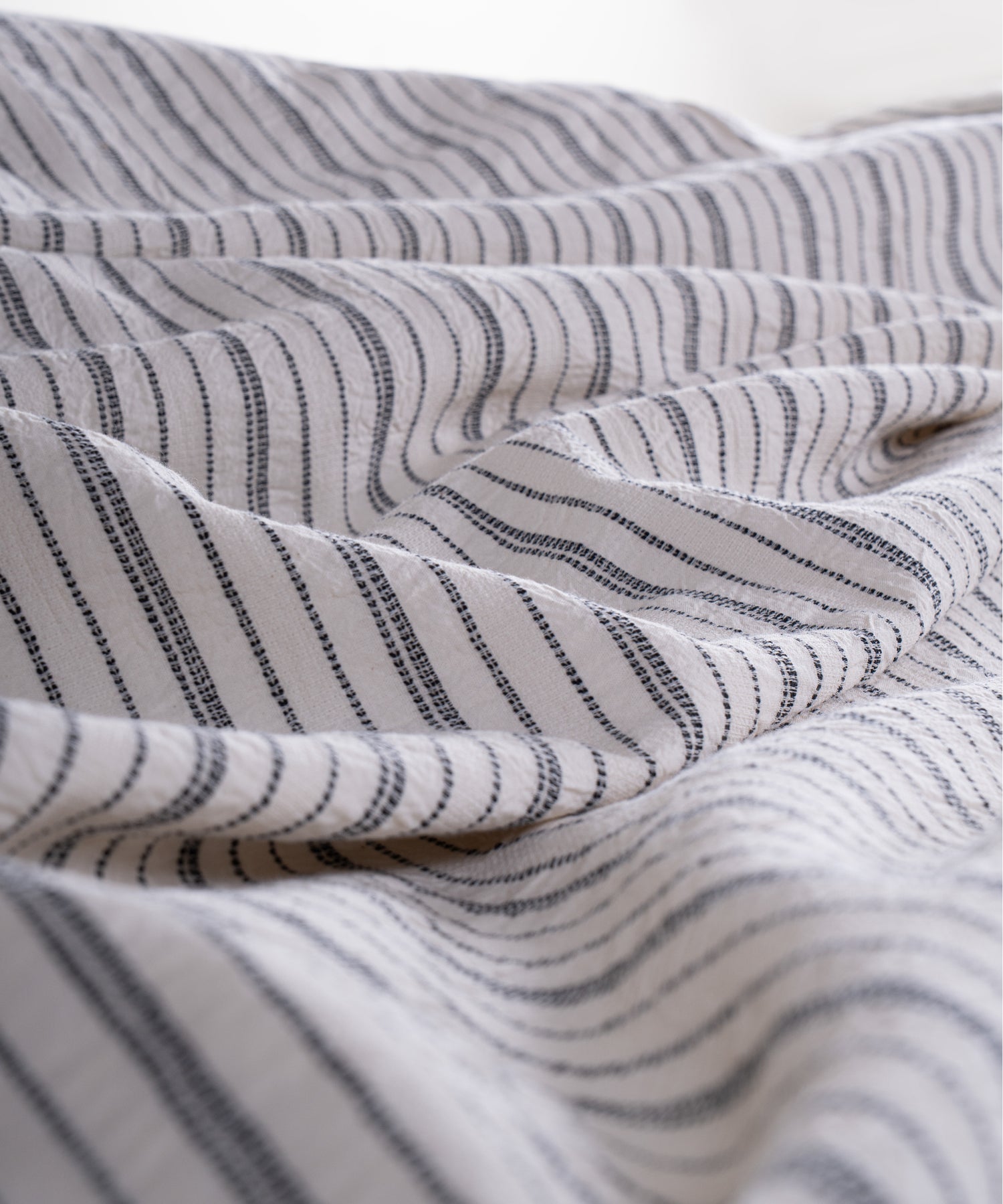 Cotton pillowcase with envelope closure in natural cream and navy dotted stripe design