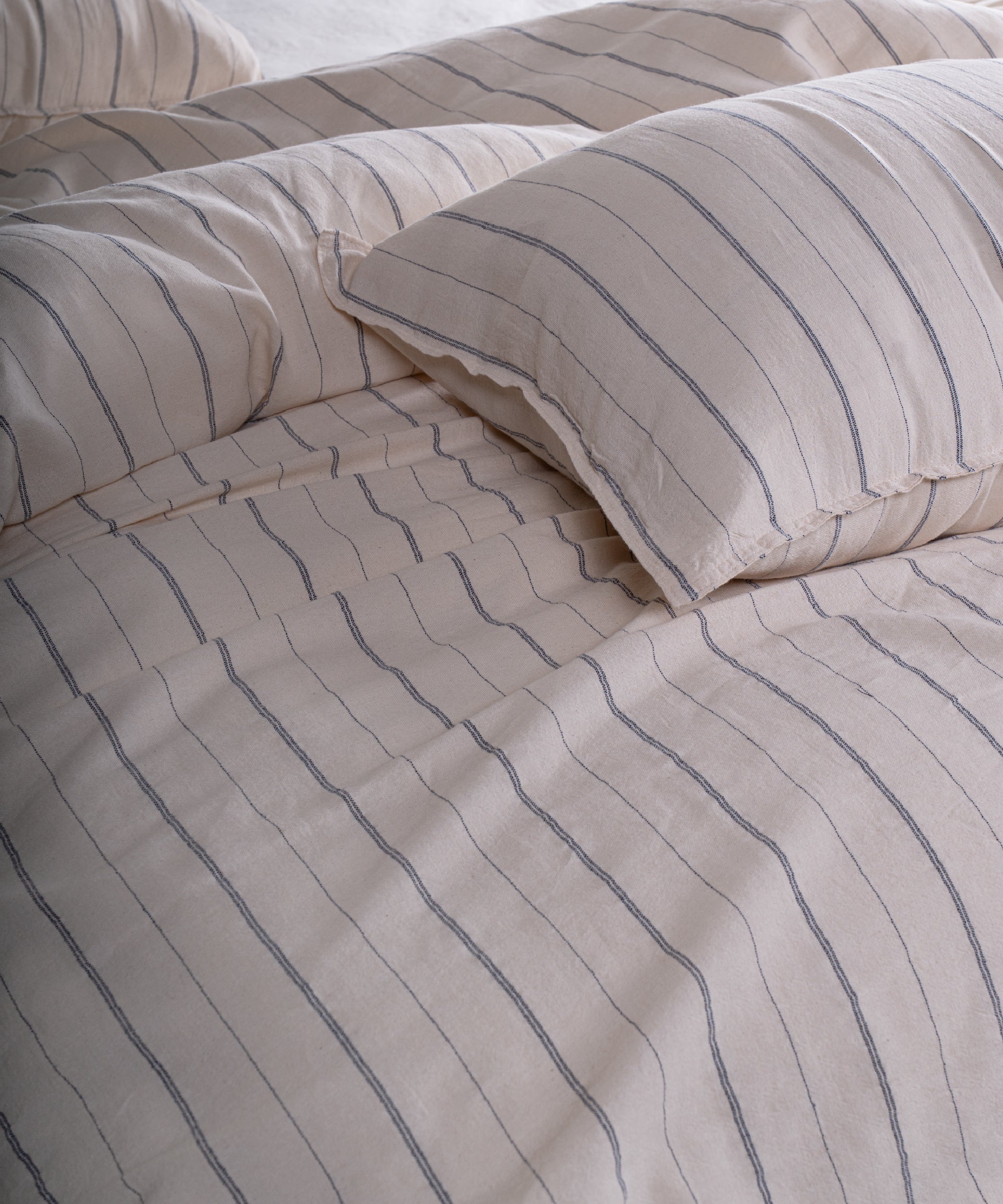 Cotton pillowcase with envelope closure in natural cream and navy stripe design