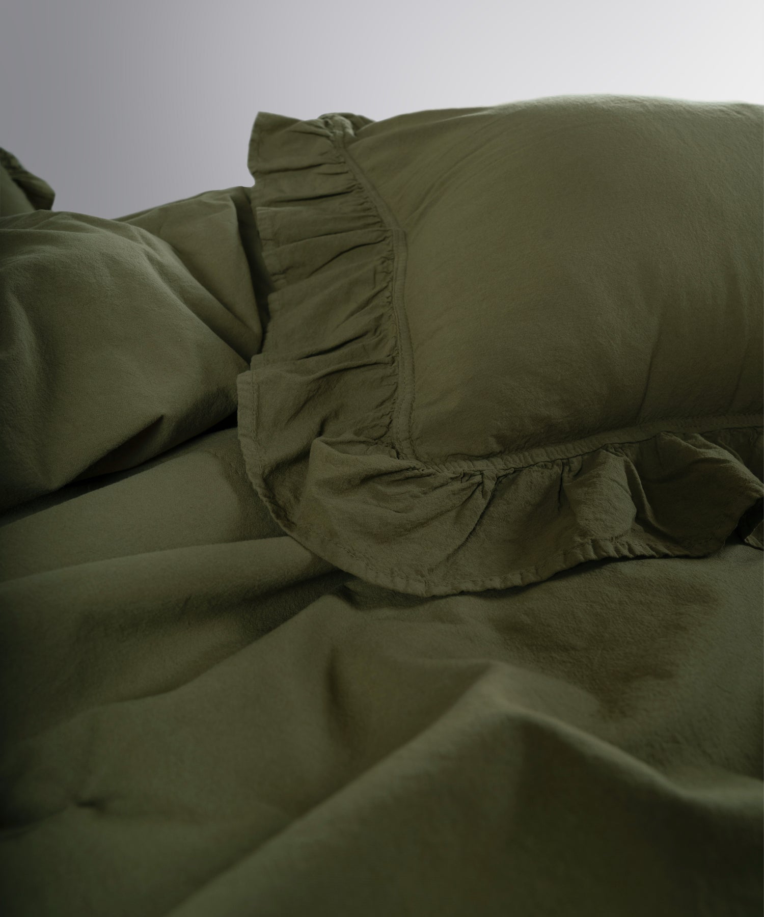 Ruffle detailed cotton pillowcases in Capulet Olive from Limasso stonewashed bedding collection
