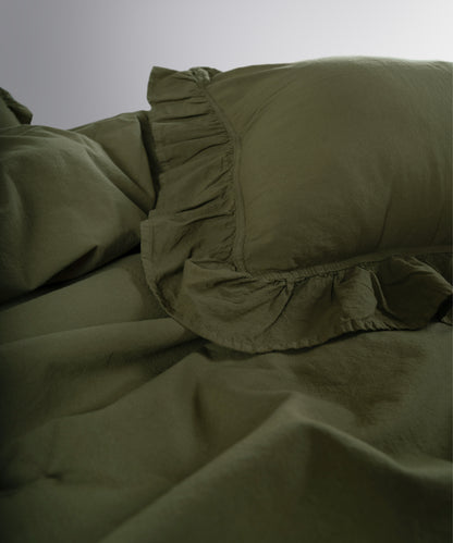 Ruffle detailed cotton pillowcases in Capulet Olive from Limasso stonewashed bedding collection
