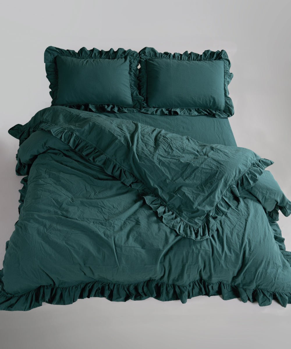 Dark green stonewashed cotton duvet cover set showing soft texture and elegant ruffle edges