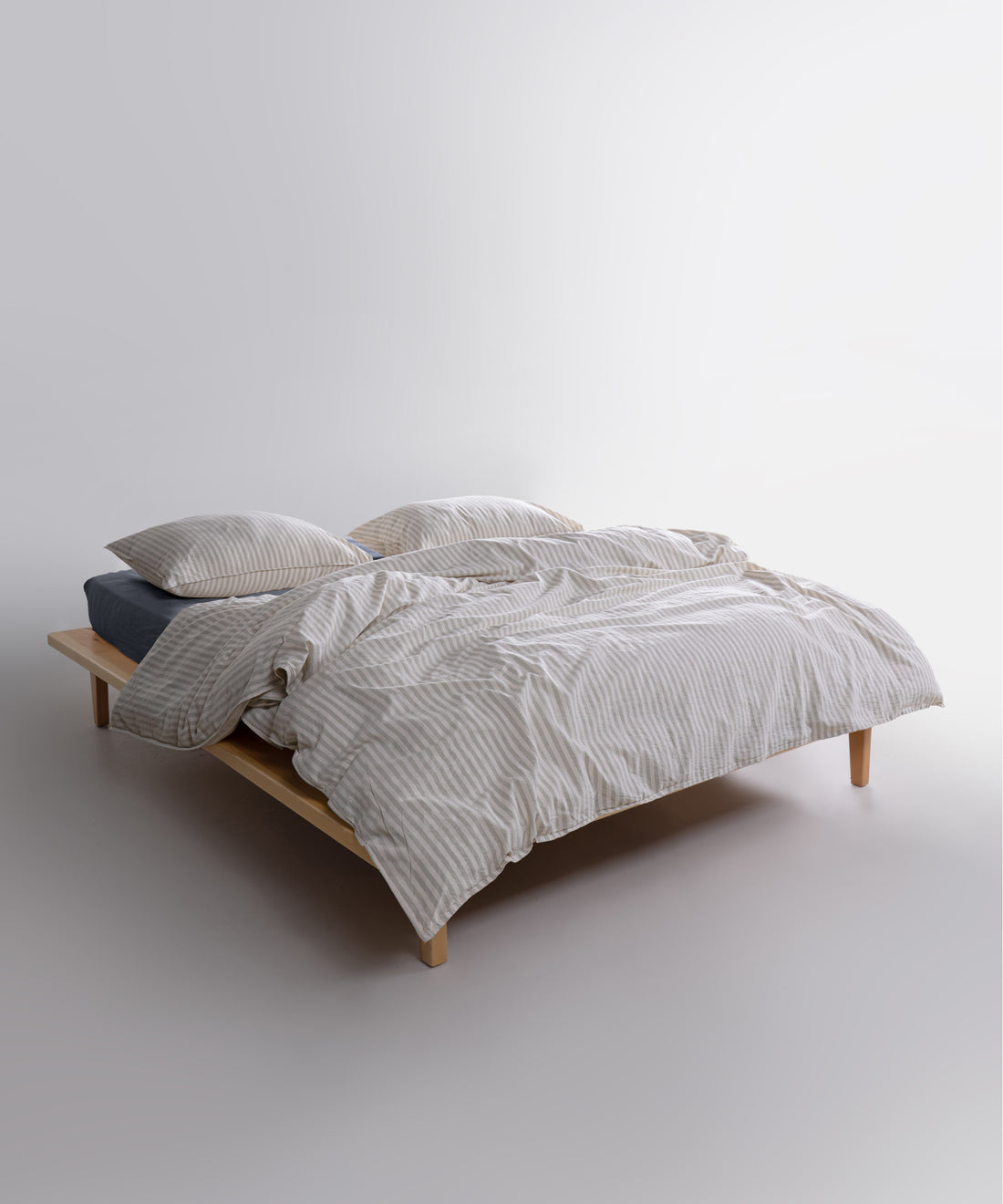 Garment washed 100% cotton duvet cover set in natural cream with soft green stripes

