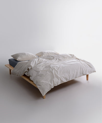 Garment washed 100% cotton duvet cover set in natural cream with soft green stripes
