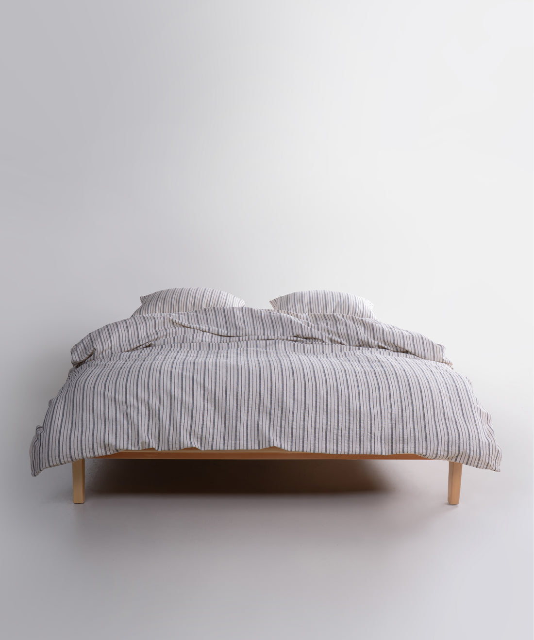 Garment washed 100% cotton duvet cover set in natural cream with navy dotted stripes for UK bedrooms