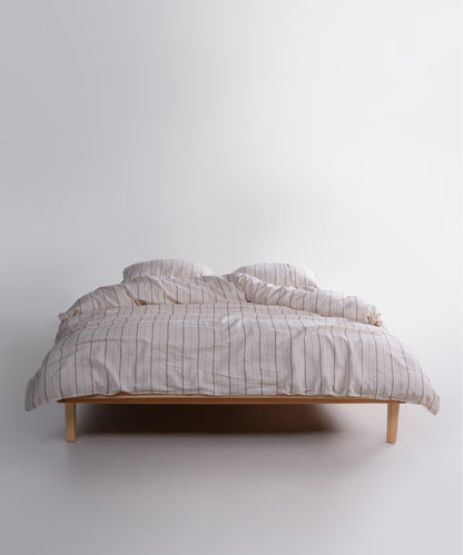 Garment washed 100% cotton duvet cover set in natural cream with navy stripes, soft breathable bedding for UK homes