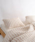 Garment washed 100% cotton duvet cover set in natural cream with red stripes and black speckle details

