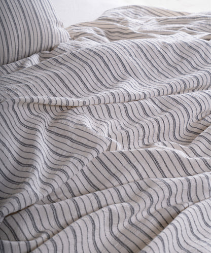 Close-up of garment washed cotton fabric with navy dotted stripe detail