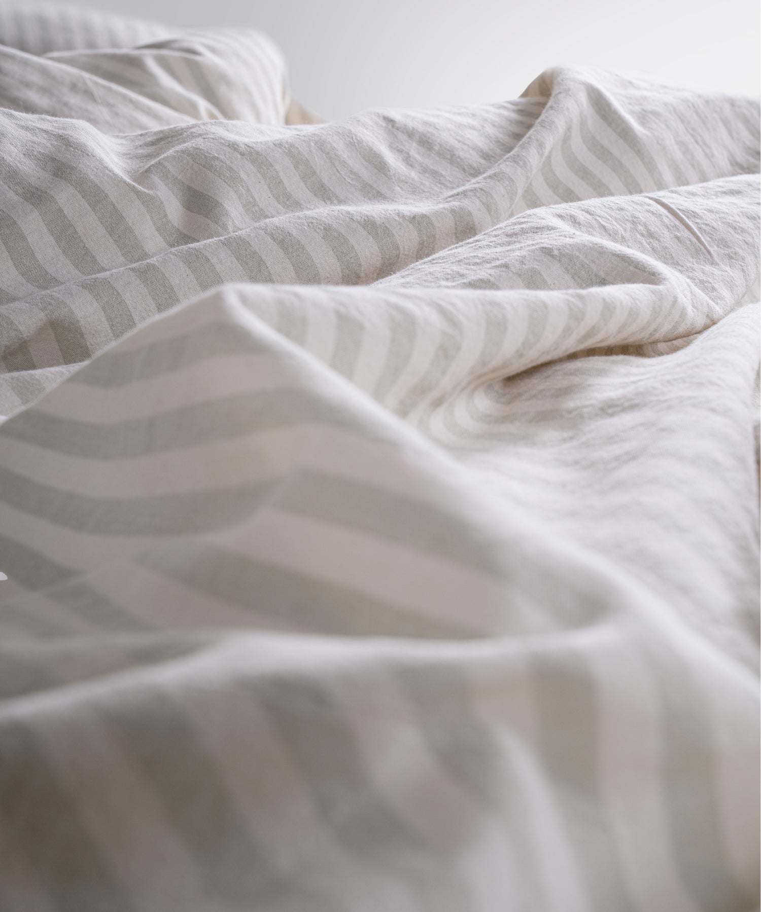 Close up of garment washed cotton fabric with soft green stripes