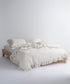 Garmenwashed Leila 100% cotton duvet cover set with natural cream fabric and black stripes, styled on a double bed