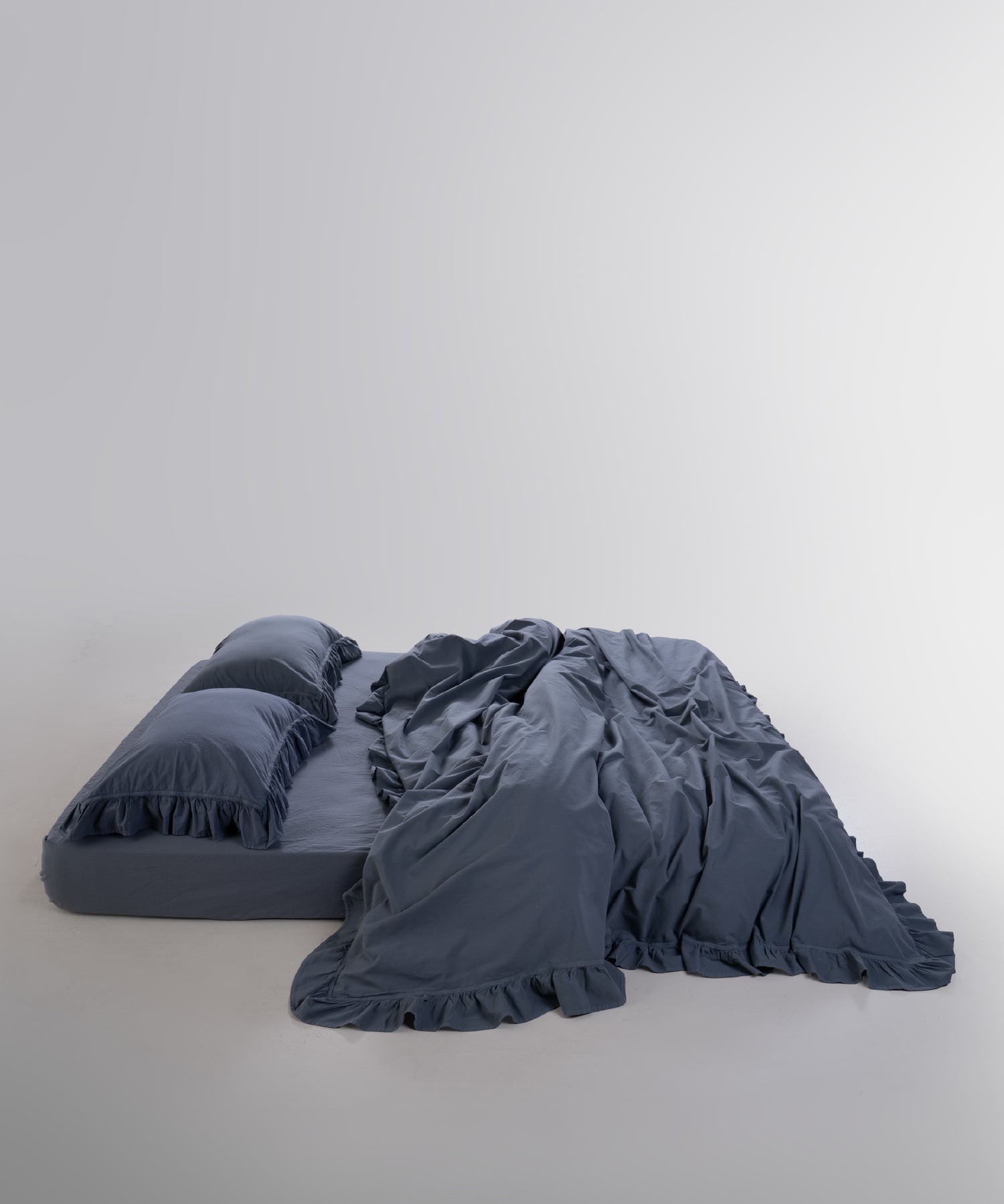 Modern bedroom styled with stonewashed cotton duvet cover set in Castle Rock anthracite