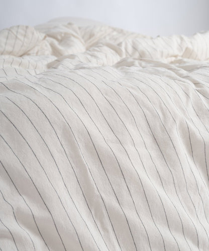 Natural cream and black striped duvet cover set in a modern UK bedroom