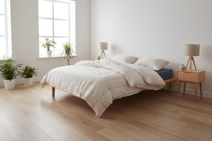 Natural striped cotton bedding set styled in a bright and calming UK bedroom interior

